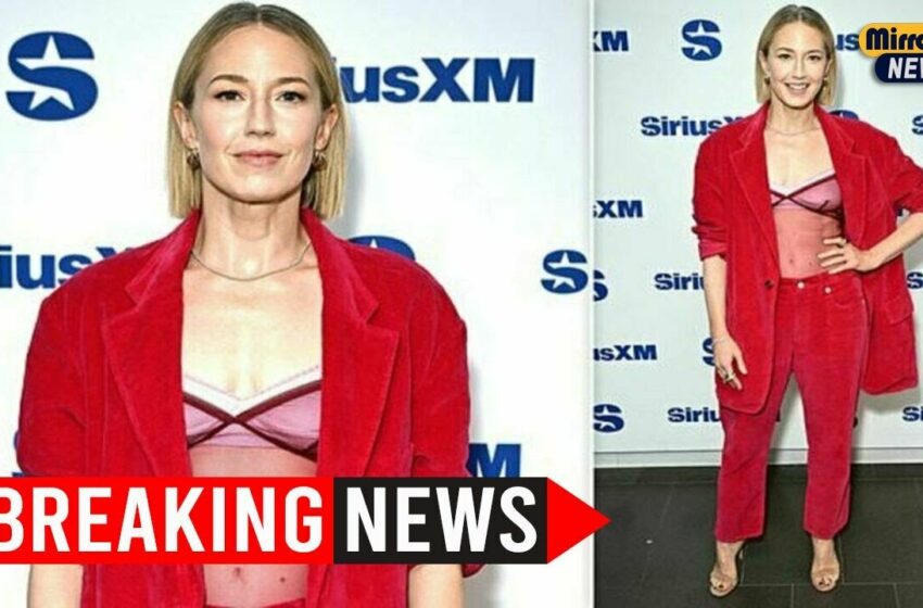  Carrie Coon Turns Heads in Bold Red Pantsuit and Sheer Tank Top in NYC